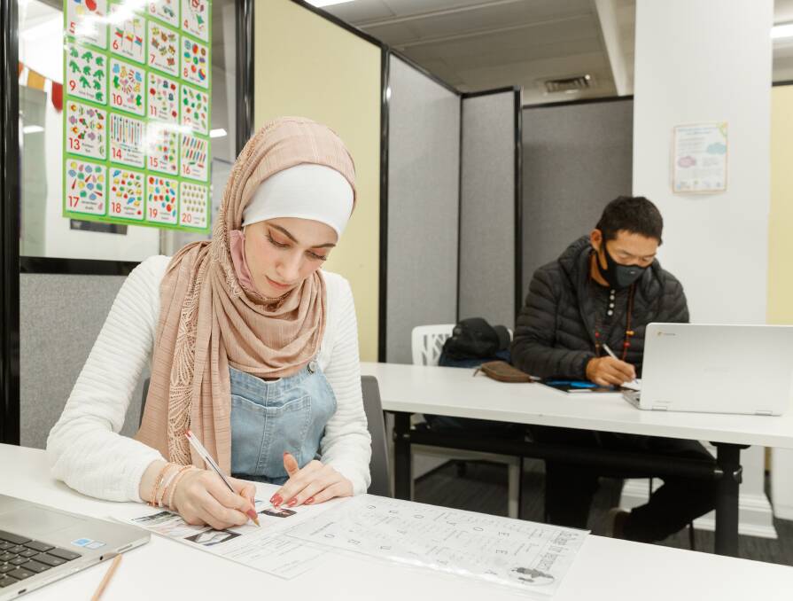Moving ahead: Bayan Abdulilah Qanso, front, and Tenzin Dhonyoe studying English in Mayfield this week. Their studies have been disrupted by the COVID shutdow. Picture: Max Mason-Hubers 