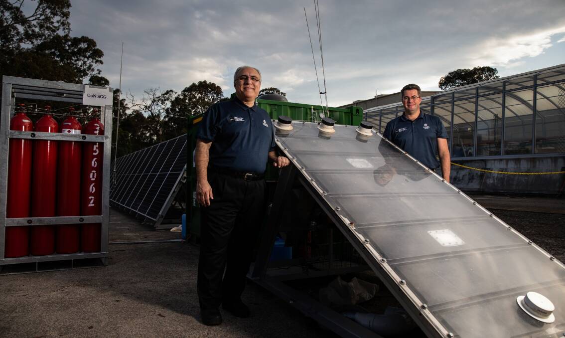 Professor Behdad Moghtaderi with Dr Andrew Maddocks and the solar Hydro Harvester. Picture: Marina Neil