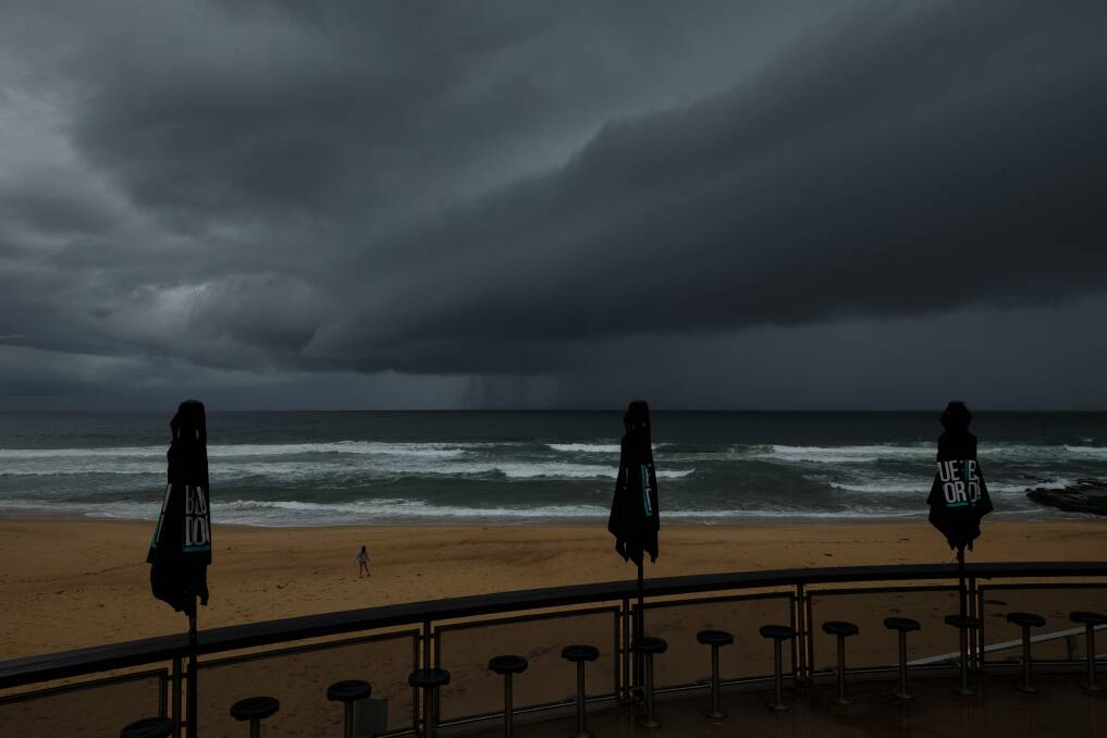 Seeking shelter: Newcastle beach was deserted for more than one reason on the weekend. Picture: Max Mason Hubers