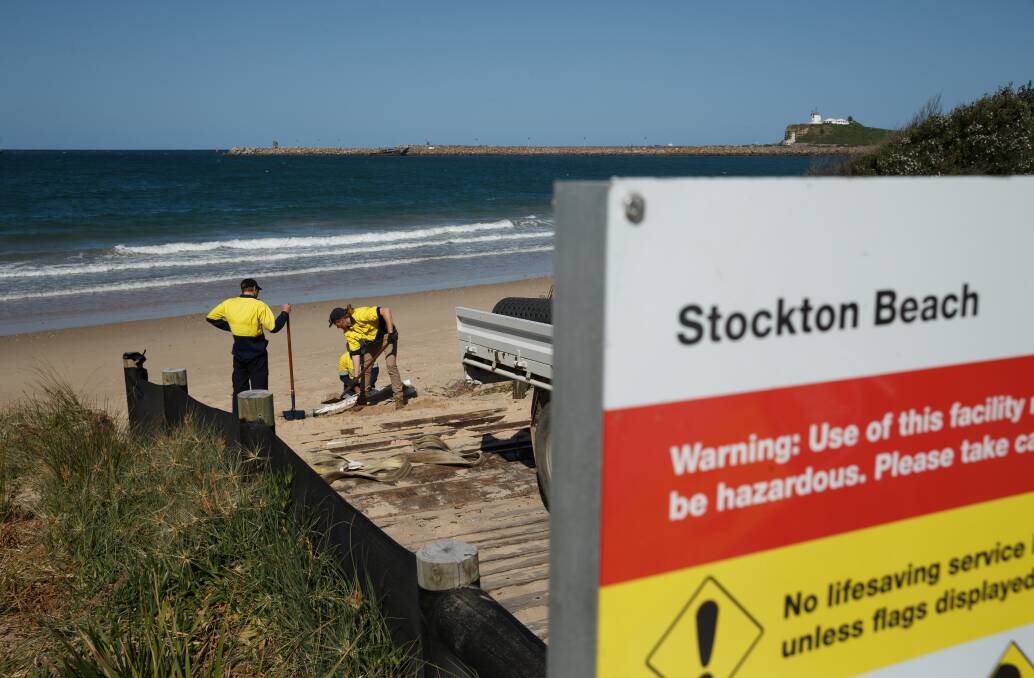 Making progress: Workers repairing the beach access way near Lexie's Cafe, Stockton on Tuesday. Truck loads of sand are expected to be dumped on the beach in coming weeks. Picture: Max Mason-Hubers.