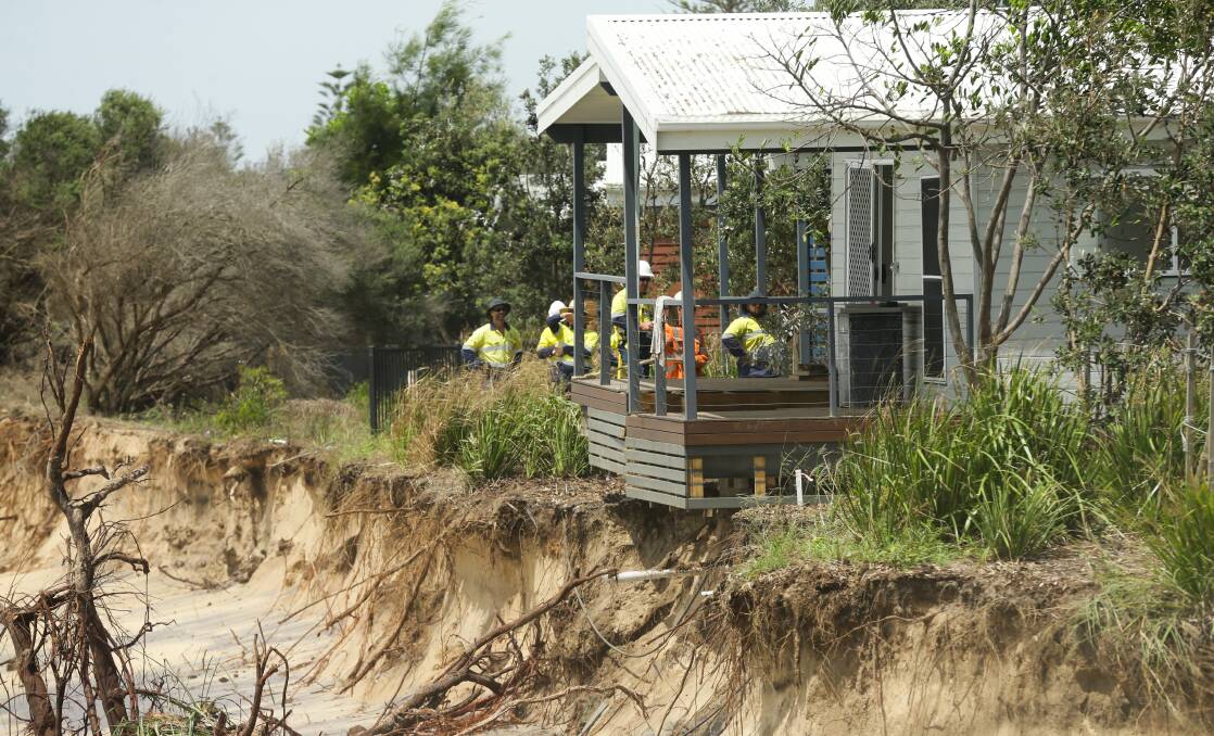 Slipping away: An extra metre of the dune was washed away while workers prepared to lift the cabin Picture: Jonathan Carroll 