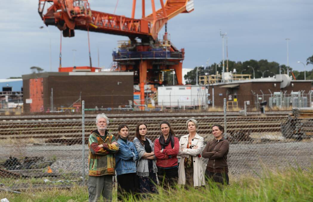 Living with coal: Tighes Hill residents, from left, John Sutton, Emma Wallace, Elle Lawless, Charlotte McCabe, Alex Wegner, Katelijn Hullegie, on Industrial Drive. Picture: Jonathan Carroll 