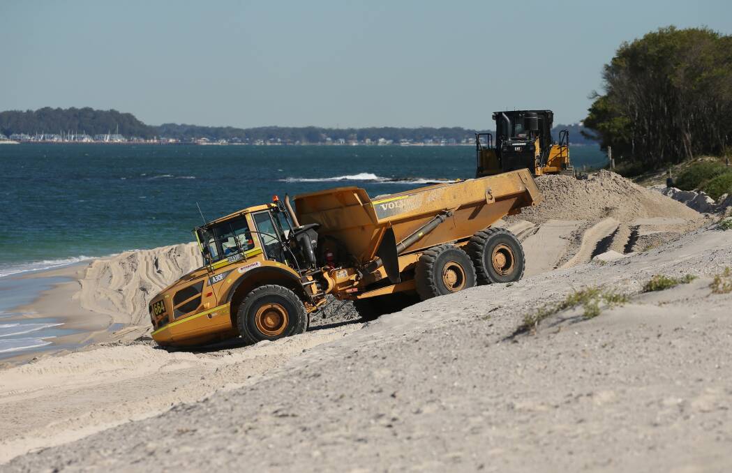Trucks dumping sand at Jimmys Beach coast erosion hotspot last Friday. Picture by Simone DePeak 