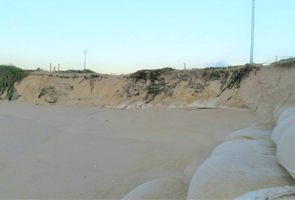 Going fast: A newly eroded area near at the northern end of Stockton Beach. Waste from the former tip will be removed. Picture: Crown Lands. 
