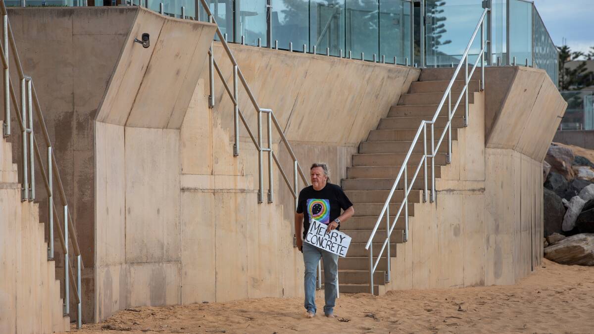 The Collaroy seawall towers over Brendan Donohoe. Mr Donohoe led the community campaign against the wall. Pictures by Marina Neil.