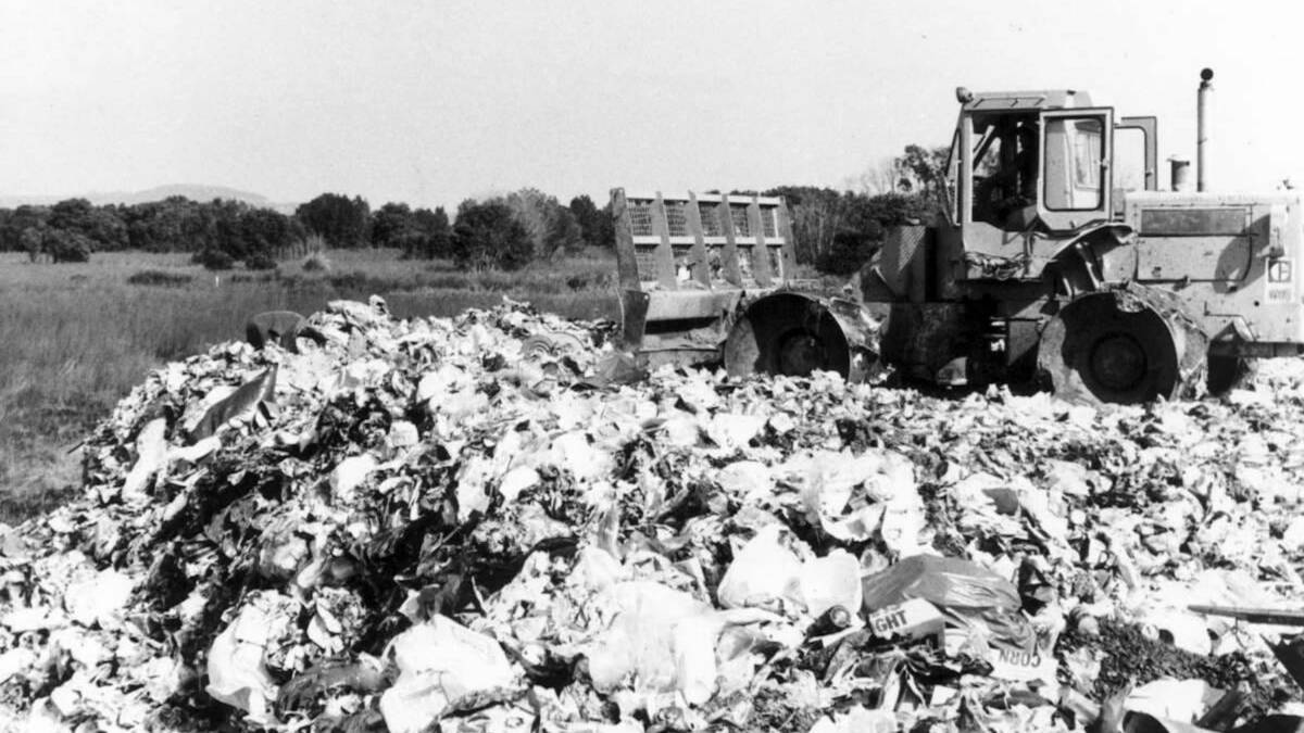 Landfill: A grader pushes garbage at the former Astor Street, Shortland tip site in the 1980s. Picture: Newcastle Herald