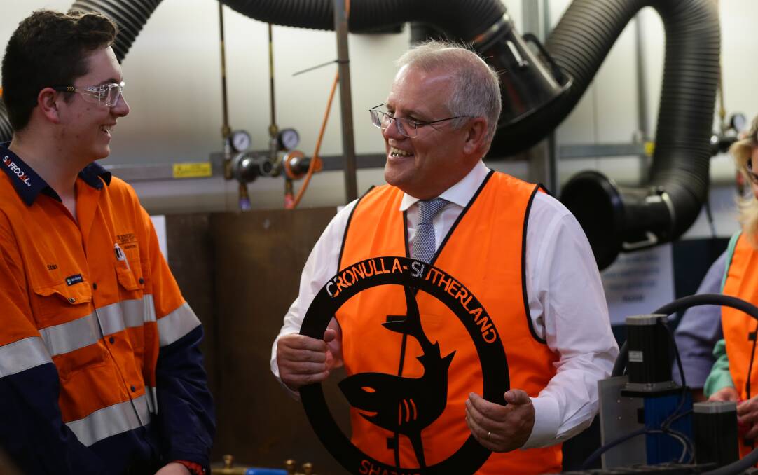 Scott Morrison speaks with an apprentice at Hunter Valley Training company in February. Picture: Jonathan Carroll 