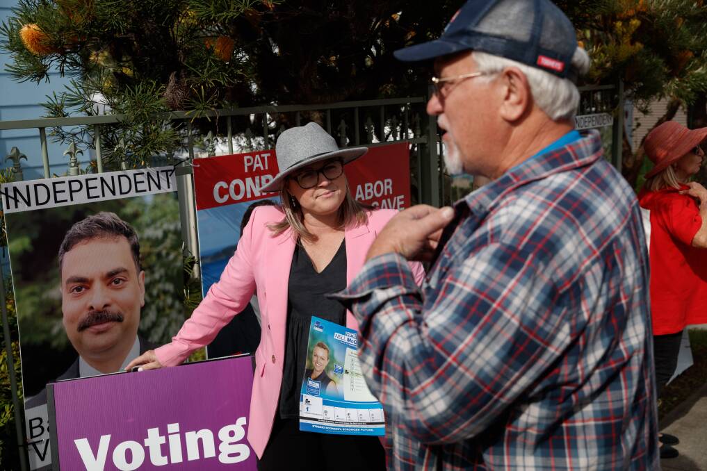 In the balance: Liberal candidate Nell McGill at the Belmont pre-poll on Thursday morning. Picture: Max Mason-Hubers.