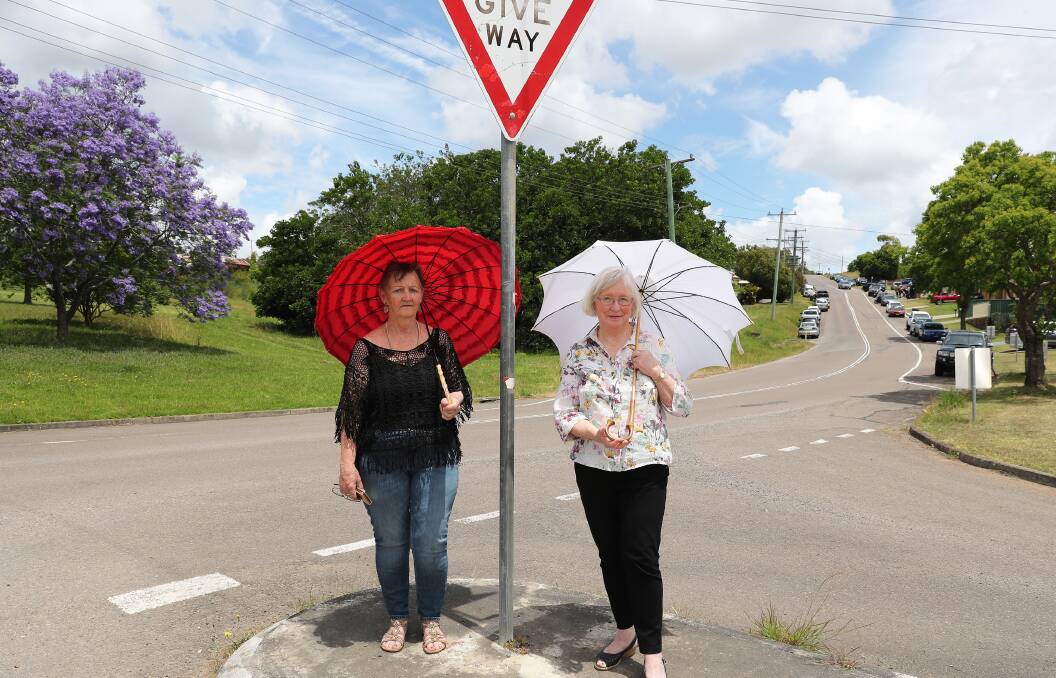 Minmi Residents Christine Baker and Kathy White in the main street of Minmi in front of some of the land which will be cleared. Picture by Peter Lorimer.