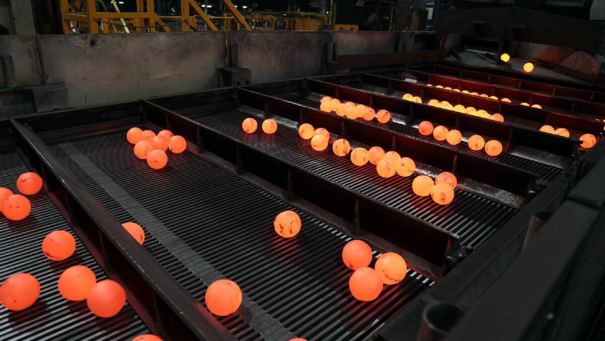 Hot stuff: Red-hot ball bearings come off the production line at the Molycop plant at Waratah. The plant has made the switch to renewable energy. 