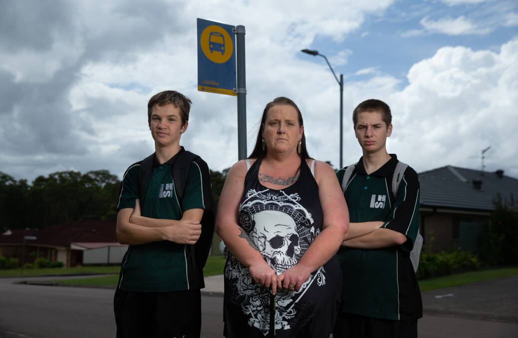 Left in the lurch: Dylan Broadfoot, 14, and Riley Broadfoot, 16, with their mum, Natalie Broadfoot at their bus stop at Medowie. Picture: Marina Neil
