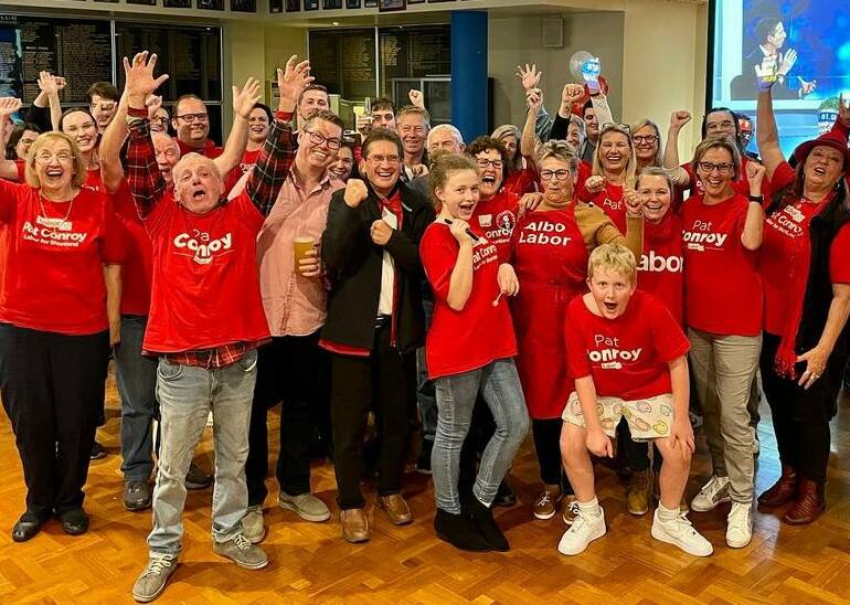 Party faithful: Pat Conroy celebrates with his supporters at Windale Bowling Club on Saturday night. Picture: Amanda Turner. 