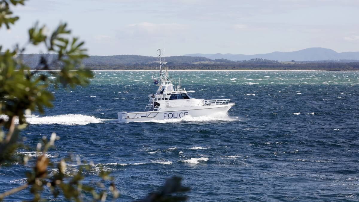 Grim search: Water police vessel "Intrepid" heads out from Nelson Bay to search for the missing helicopter on Monday morning. Picture: Darren Pateman.