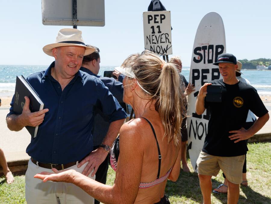 Opposition Leader Anthony Albanese discusses his concerns about the proposed offshore gas exploration licence with a local at Terrigal on Friday. Picture: Max Mason Hubers. 