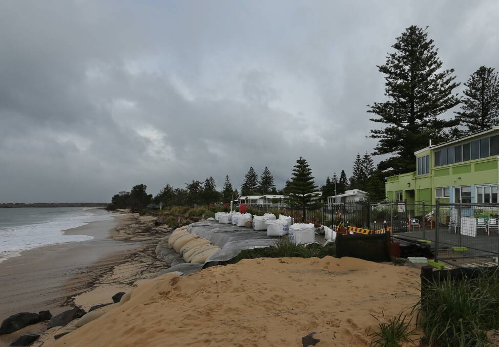 Reinforcements: A new line of sand bags outside Lexie's Cafe. The section of foreshore has lost more sand in recent days. Surf conditions are expected to ease in coming days. Picture: Simone De Peak