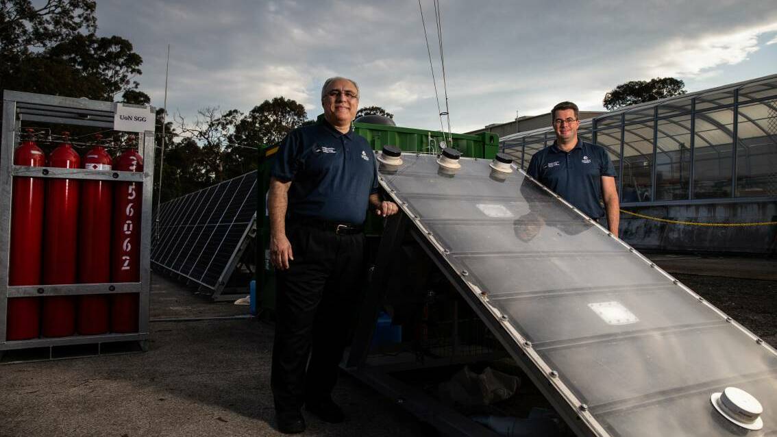 Professor Behdad Moghtaderi with Dr Andrew Maddocks and the solar Hydro Harvester. Picture: Marina Neil.