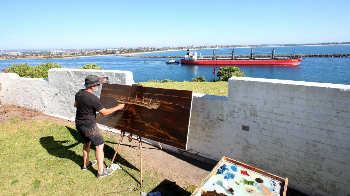 Artist Dino Consalvo painting ships from Nobbys Headland. Picture: Dean Osland