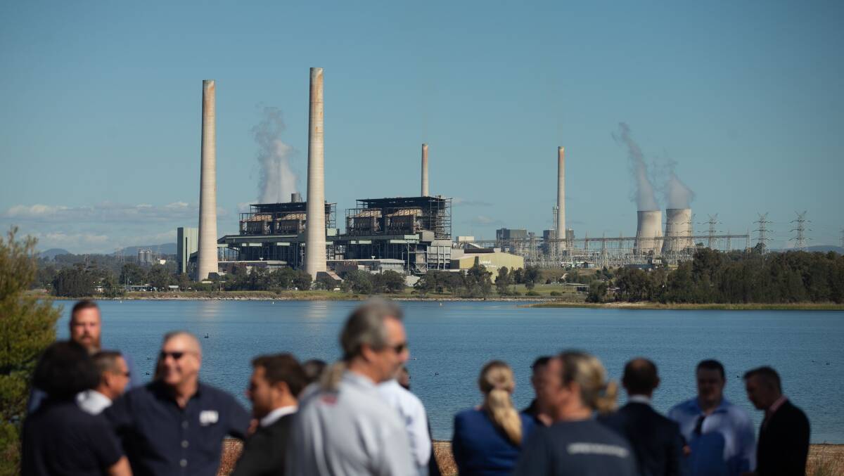 The recently closed Liddell Power Station loomed large at Friday's announcement. Picture by Jonathan Carroll.