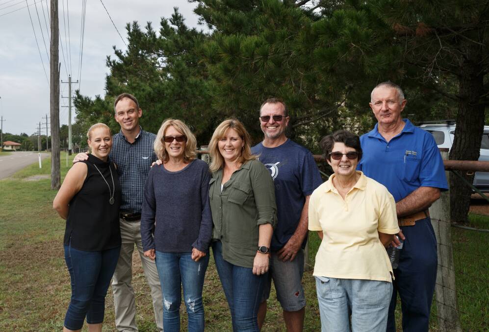Sticking together: Williamtown class action members Rhianna Gorfine, Cain Gorfine, Sue Walker, Kim Smith, Gavin Smith, Ann Clout and Lindsay Clout at the Clout family's business in Fullerton Cove. Picture: Max Mason-Hubers