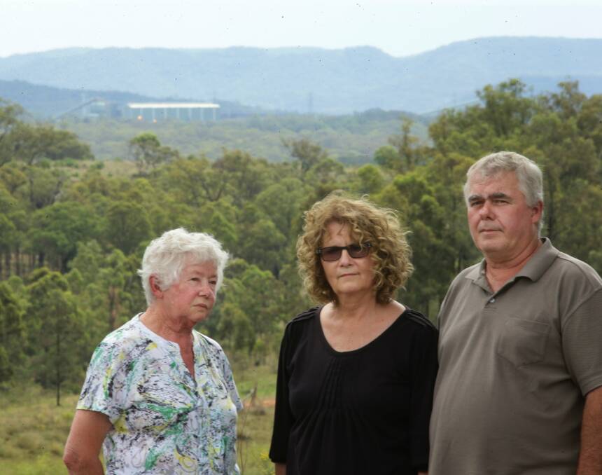 Community: Peter and Julie Brown with Peter's mother June near Mangoola mine. The mine's rail loop is in the background. Picture: Peter Stoop