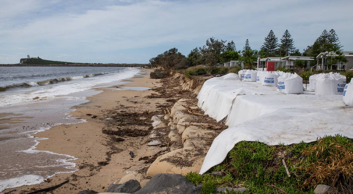 Sorry sight: A badly eroded part of the Stockton foreshore near the caravan park. Sand bags have been used to temporarily stabilise the area.