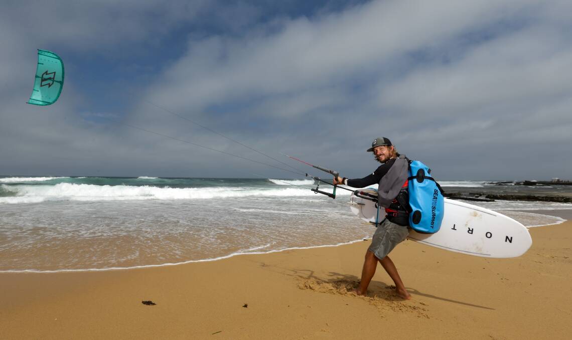 The life of Brian: Brian Kiss von Soly testing his equipment at Merewether Beach on Sunday. He is waiting for favourable winds to allow him to continue his journey. Picture: Jonathan Carroll