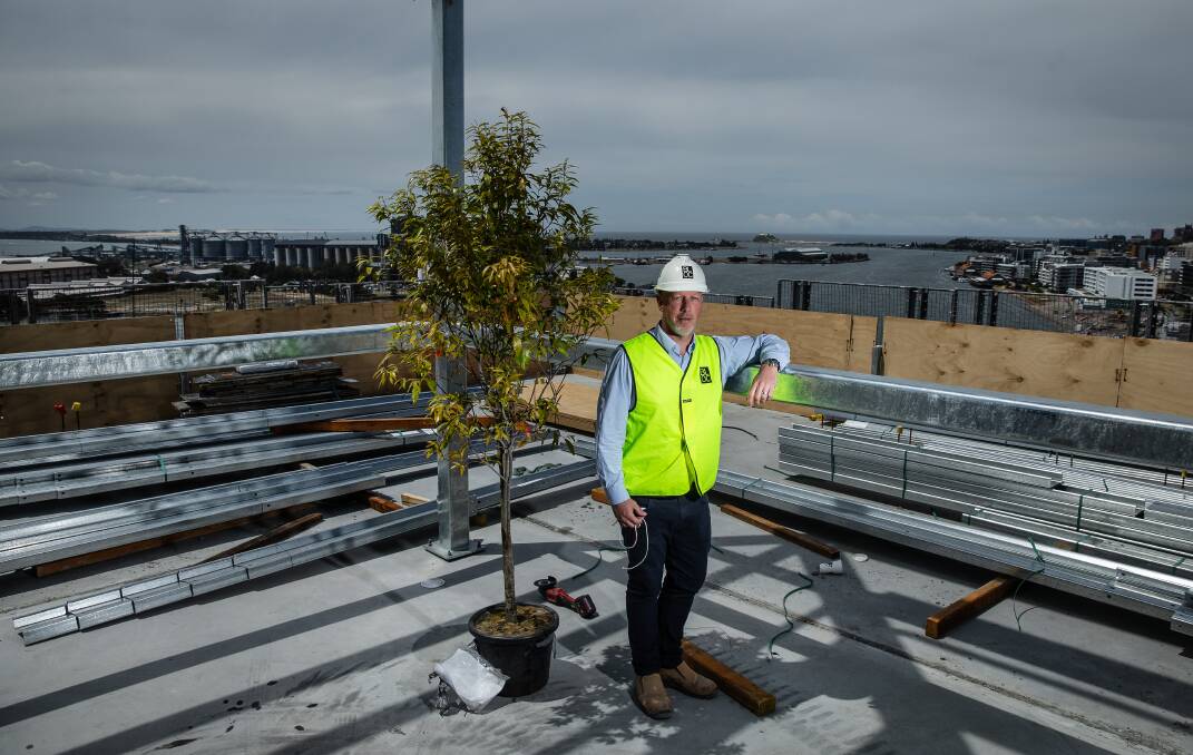 Topping out: Matt Walker atop the new office tower on Thursday. Picture: Marina Neil.
