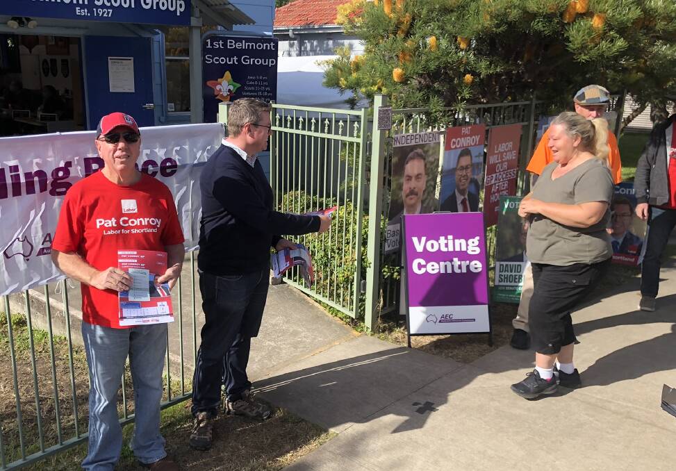 Feeling positive: Pat Conroy vying for votes at Belmont with Labor volunteer Ray Butterworth. 