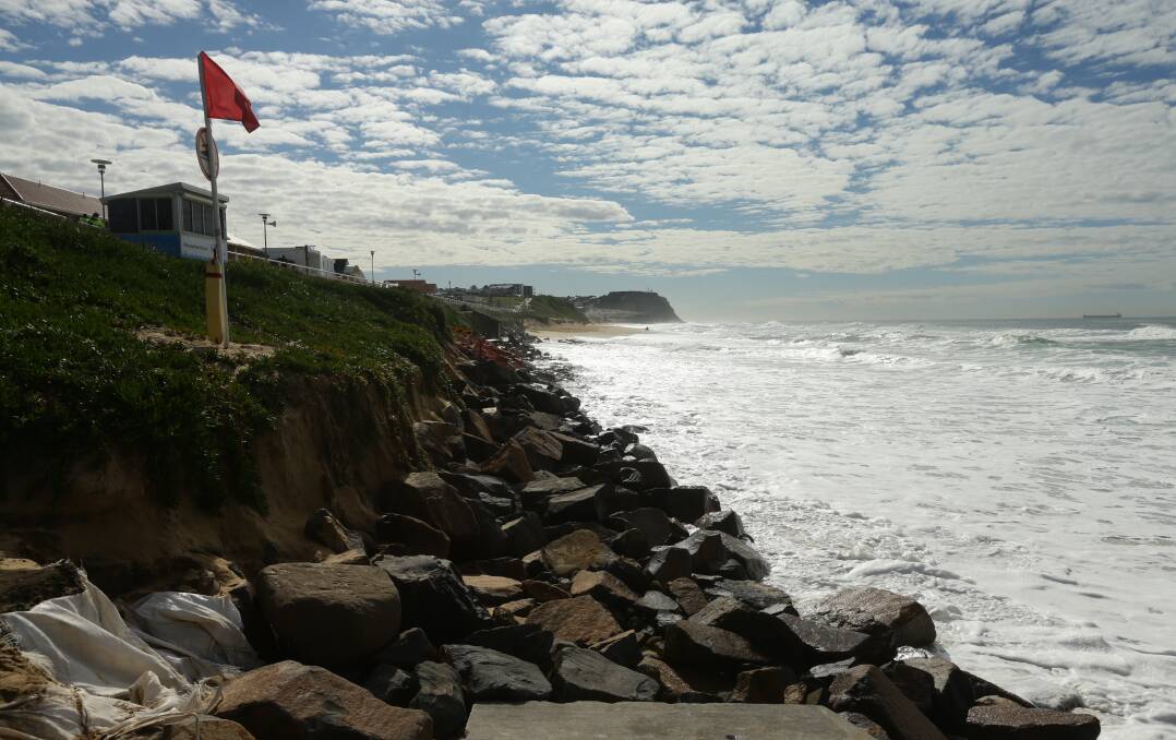 A rare event: Severe erosion at Merewether Beach on Friday. Locals say the beach has not been so badly eroded since 1974. Sand is expected to return to the beach by Christmas. Picture: Jonathan Carroll.