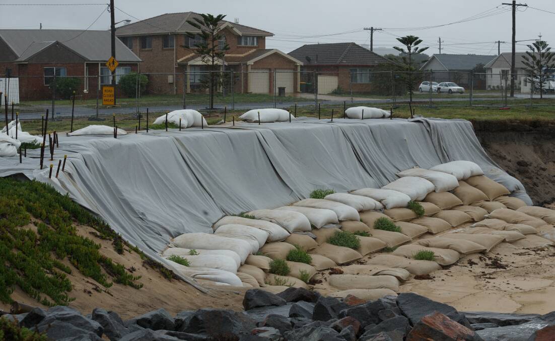 Preparing for the worst: Sandbagging around Barrie Crescent, Stockton on Friday. City of Newcastle has applied for funding to complete the emergency work. Picture: Max Mason Hubers