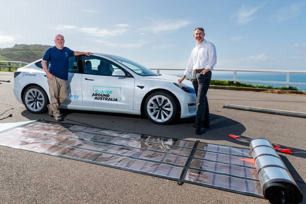 Charge Around Australia director and driver Stuart McBain (L) with Professor Paul Dastoor with the portable printed solar cell charging station. Picture by Max Mason Hubers