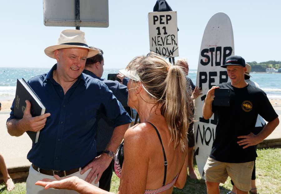 Anthony Albanese discusses his concerns about the proposed offshore gas exploration licence with a local at Terrigal in February 2021. Picture: Max Mason Hubers.