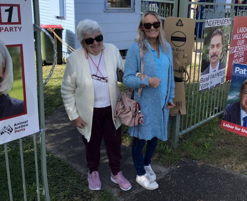 Democracy in action: Judy and Lynda Williams leaving the Belmont pre-poll booth. 