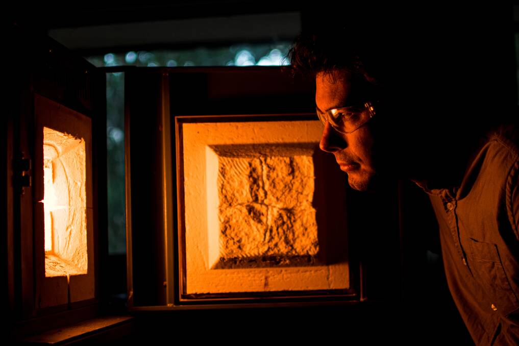 HEATING UP: Dr Dylan Cuskelly is part of the team developing a material
that can store thermal energy at the University of Newcastle. Picture: Simon McCarthy