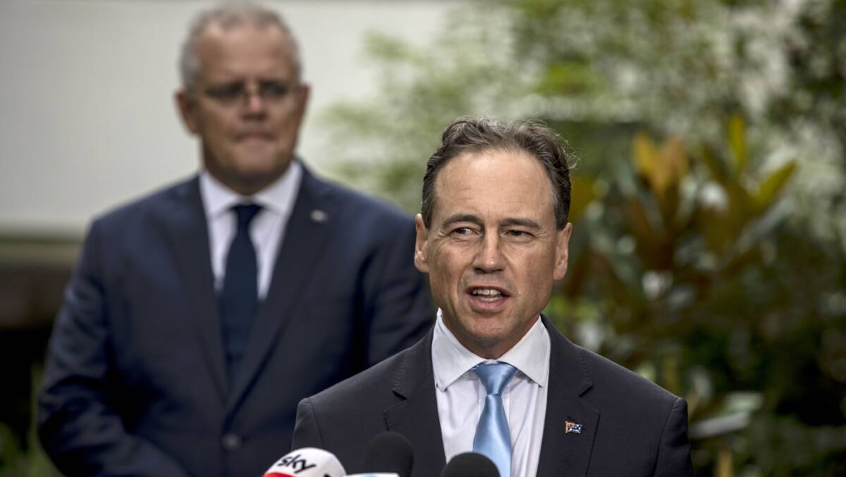 Health Minister Greg Hunt speaks as Prime Minister Scott Morrison looks on at the Melbourne CSL facility earlier this month. Picture: Getty Images