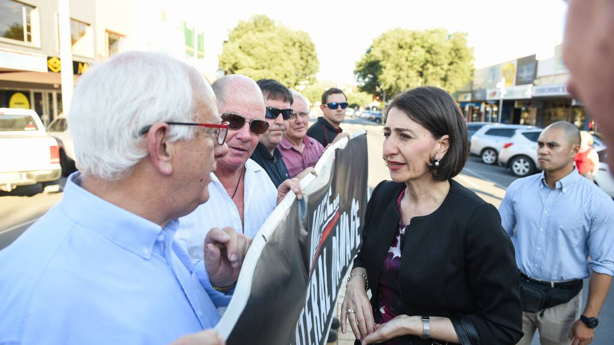Flashback: Gladys Berejiklian listens to concerned supermarket owners who conducted a protest on a Dean Street median strip about the NSW government's container deposit scheme in 2017.