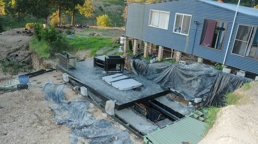 The Elands property where police allegedly found the boy locked in a shed. This shows the hydraulic-powered deck partially moved away to show the trapdoor which leads to three buried shipping containers where a large hydroponic cannabis set up was allegedly discovered. 