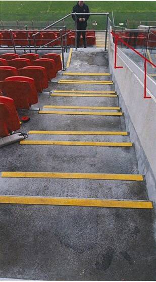 A photo of the stairs, which did not have yellow nosing strips at the time of the fall, with a red handrail drawn where an expert recommended it. Picture supplied by NSW Court of Appeal