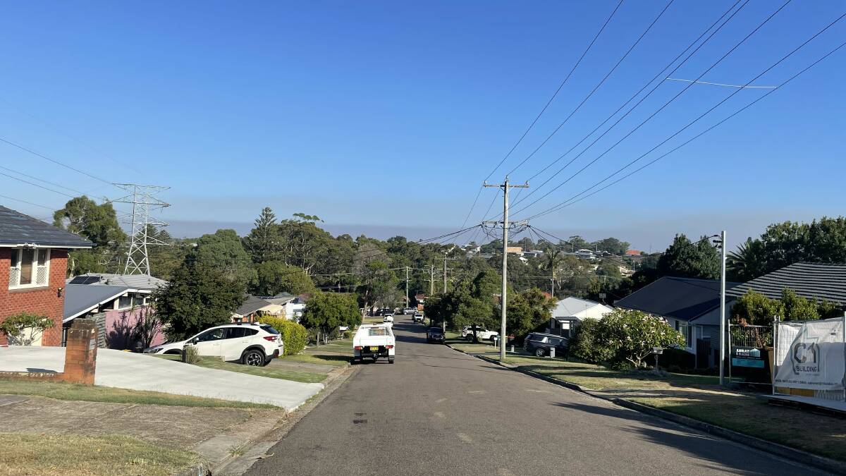 Smoke haze from a Lake Macquarie suburb on Monday afternoon. Picture supplied