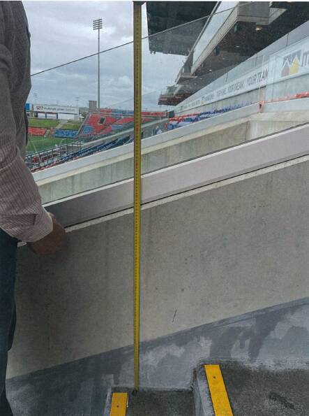 The glass balustrade on top of the concrete wall on the aisle at McDonald Jones Stadium. Picture supplied by NSW Court of Appeal