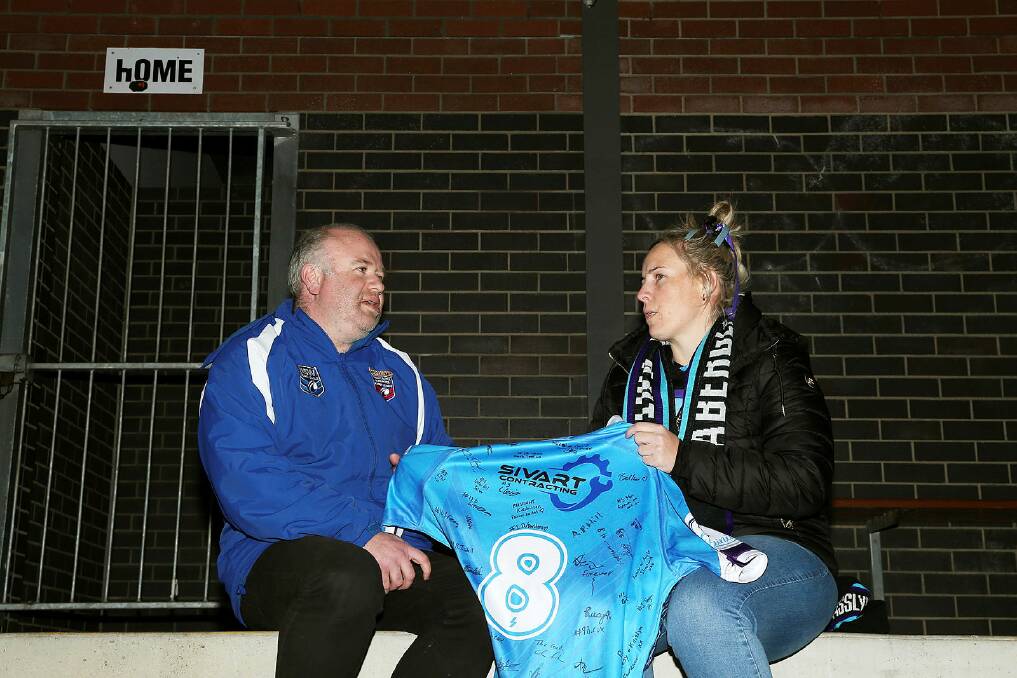 Newcastle and Hunter Community Rugby League secretary Nathan Errington and Aberglasslyn Ants president Kirsten Robinson with the Ants' number eight jersey. Picture by Peter Lorimer