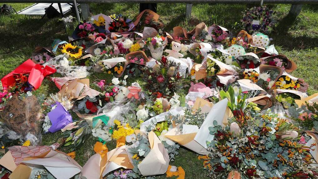 Flowers amassed at the scene of the Hunter Valley bus crash. Picture by Peter Lorimer
