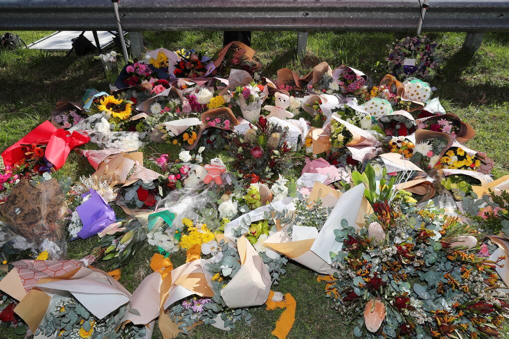Flowers amassed at the scene of the Hunter Valley bus crash. Picture by Peter Lorimer
