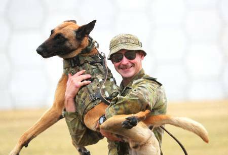 Leading aircraftman James Reid with his military working dog Drak. Picture by Peter Lorimer