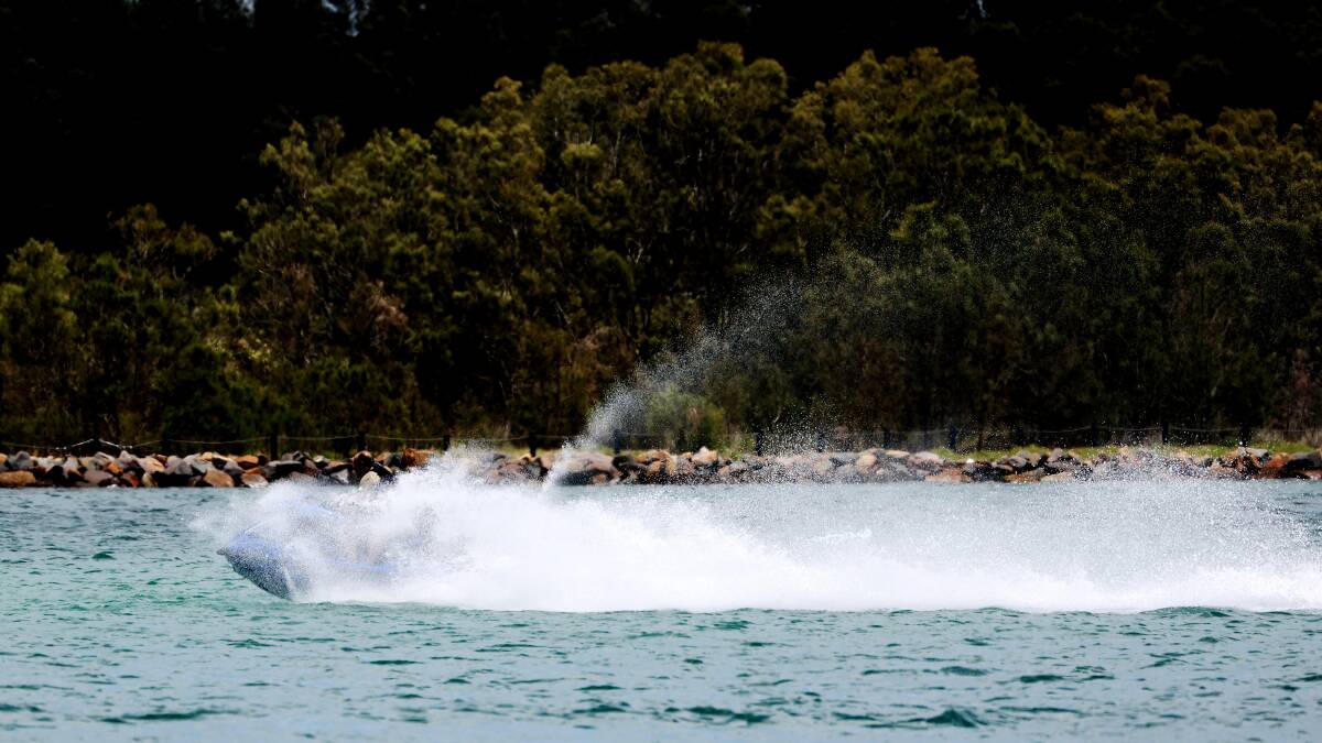 A jet ski rider makes a splash at Lake Macquarie on Wednesday. Picture by Peter Lorimer