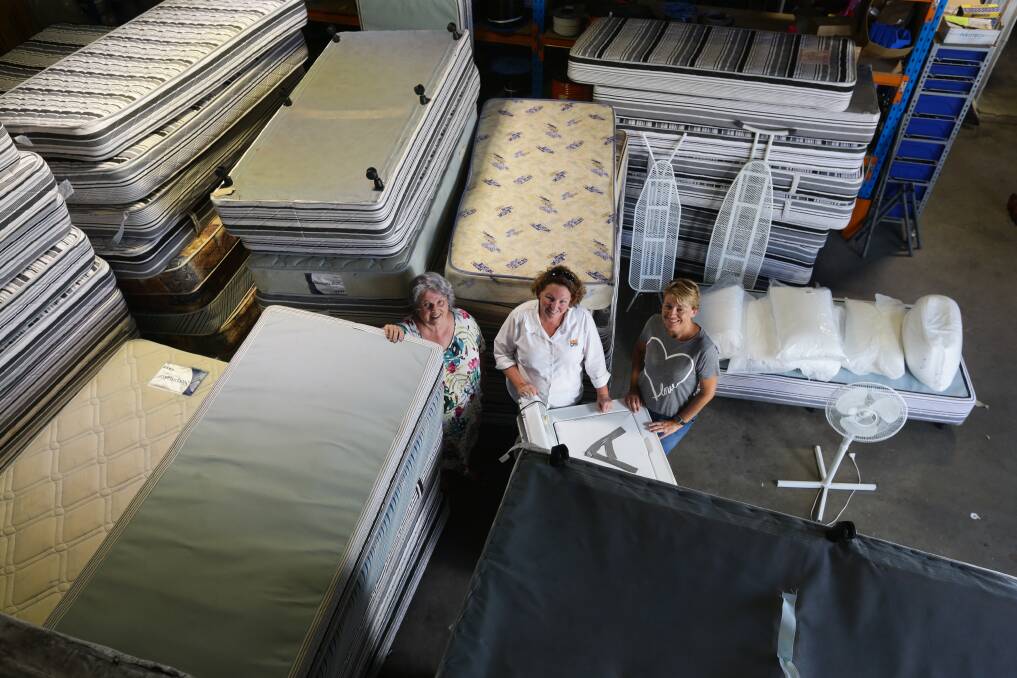 BED BOUNTY: Charity Friends With Dignity has received a bulk donation of beds and other furniture from the RAAF base at Williamtown. Pictured from left: Debbie Scott, Tracey Medley and Catherine Woodbine. Picture: Jonathan Carroll