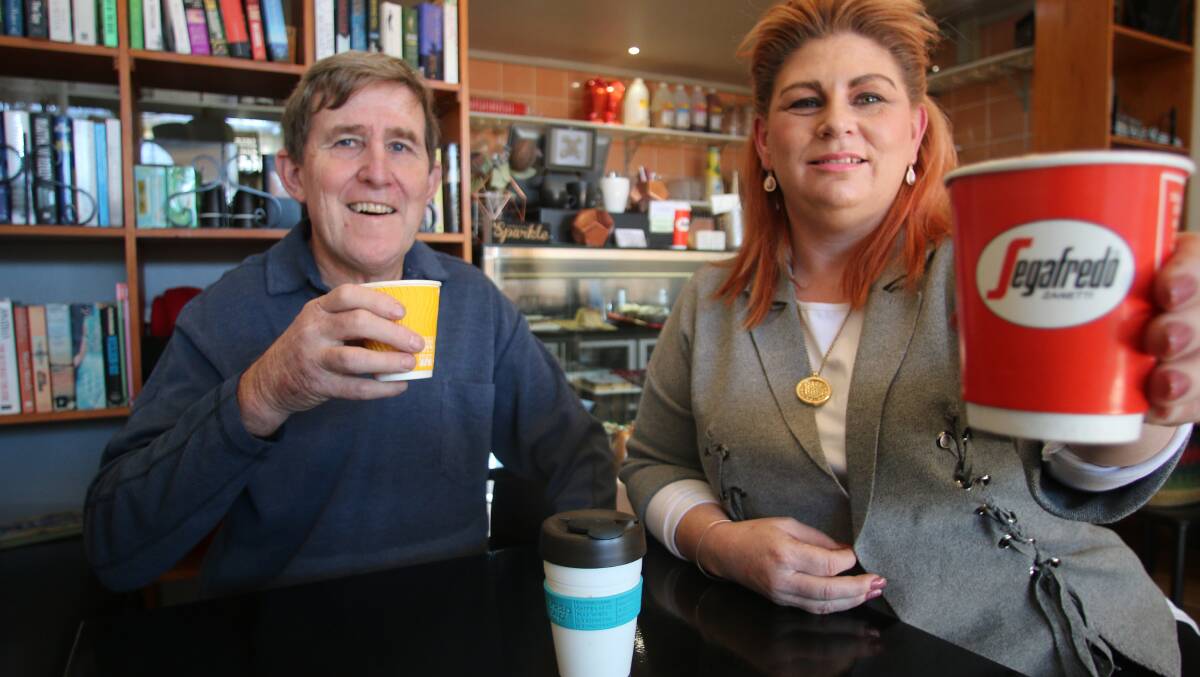 CHANGING HABITS: Steve Dewar with Rebecca Walsh at Essence Cafe, in Toronto, which now serves coffee in recyclable cups, and even coffee mugs and cups that customers bring from home. Picture: David Stewart