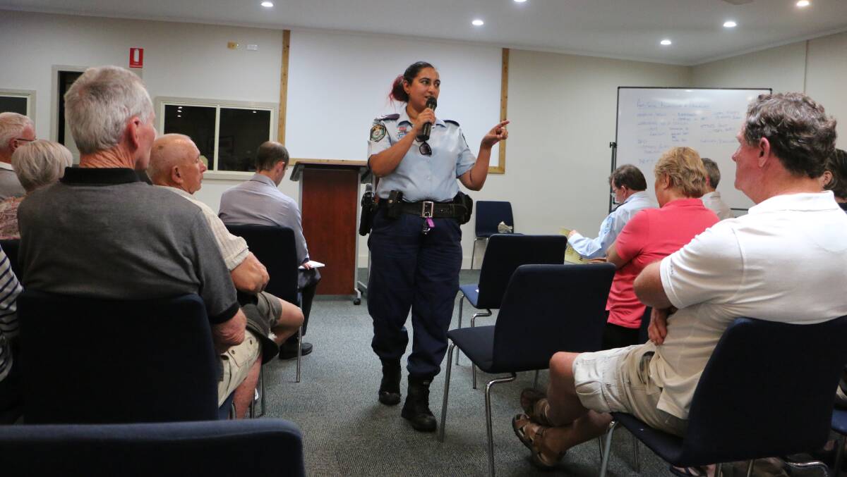 LOCAL KNOWLEDGE: Rathmines residents discuss their crime and anti-social behaviour concerns with Senior Constable Sharm Whitehead, of Lake Macquarie Police District, at a community meeting last year. Picture: David Stewart