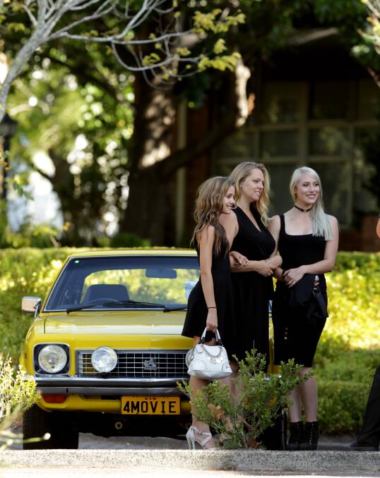 FAVOURITE CAR: Michael and Ingrid Chamberlain's daughter, Zahra, right, with her father's 1977 Torana hatchback. Picture: Simone De Peak
