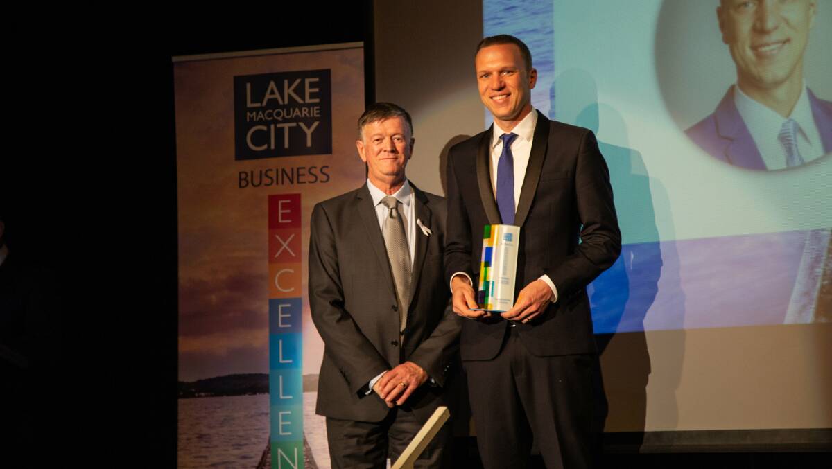 Gunther Neumann, right, on stage at the Lake Macquarie Business Excellence Awards. Picture: Supplied.  